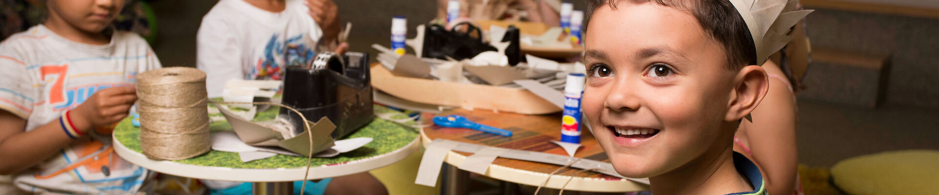 Children making paper costumes