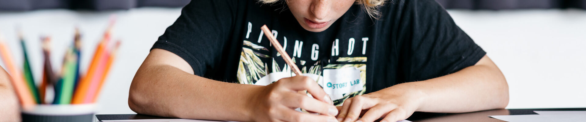 Teenager creating a book