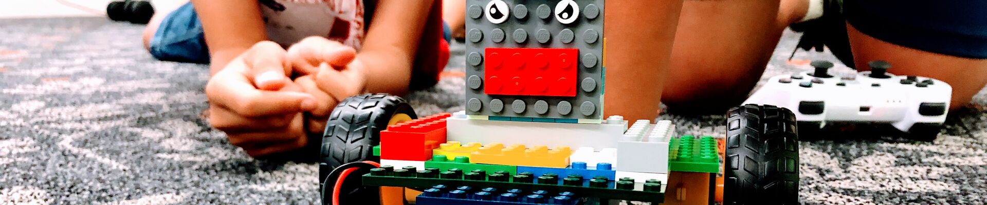 Young people with a custom built Lego robot. Young people with a custom built Lego robot