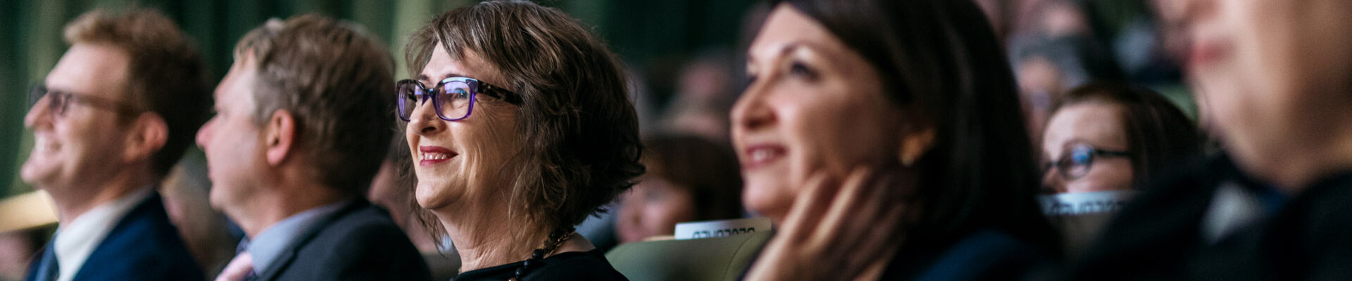 Row of people seated in an auditorium looking upwards