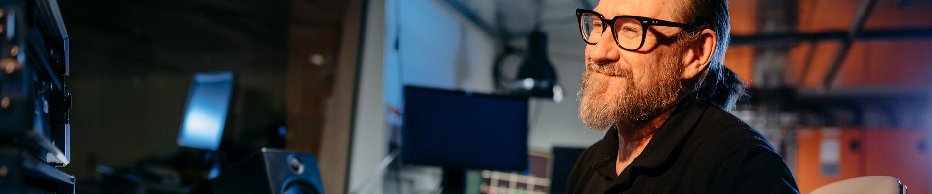 Man with both hands placed on audio equipment
