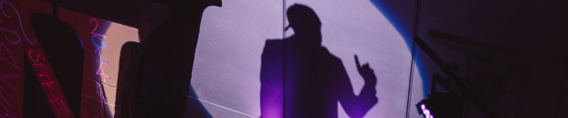 Poetry Slam 14 Silhouette of person performing at Poetry Slam