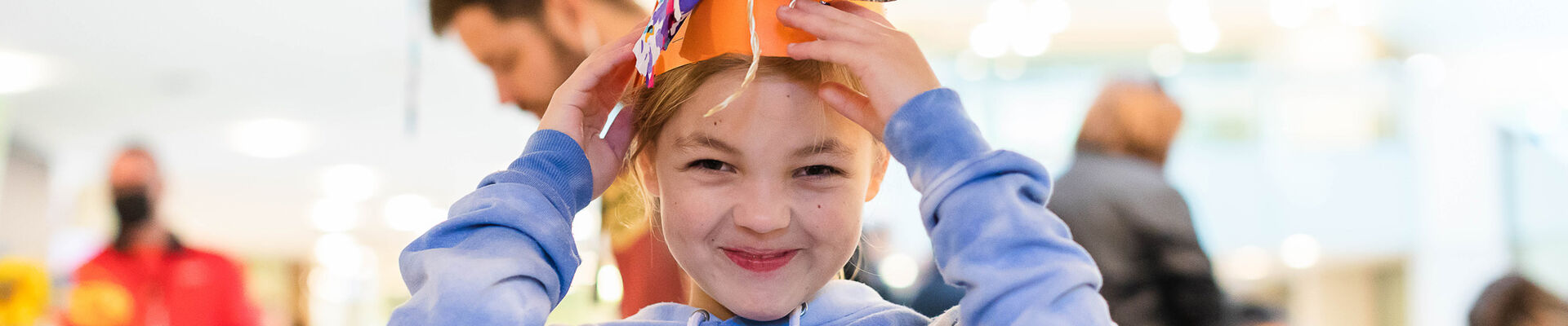 Happy child wearing a fun craft hat