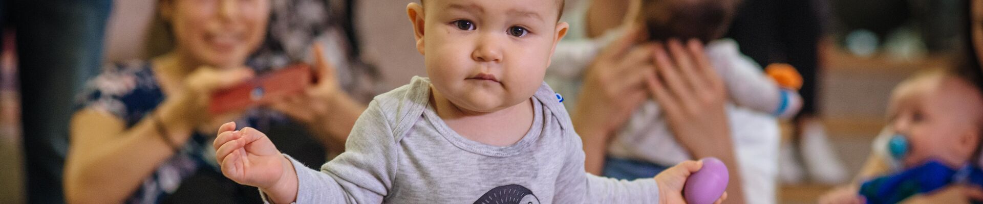 Baby in penguin top dancing at Rhyme Time