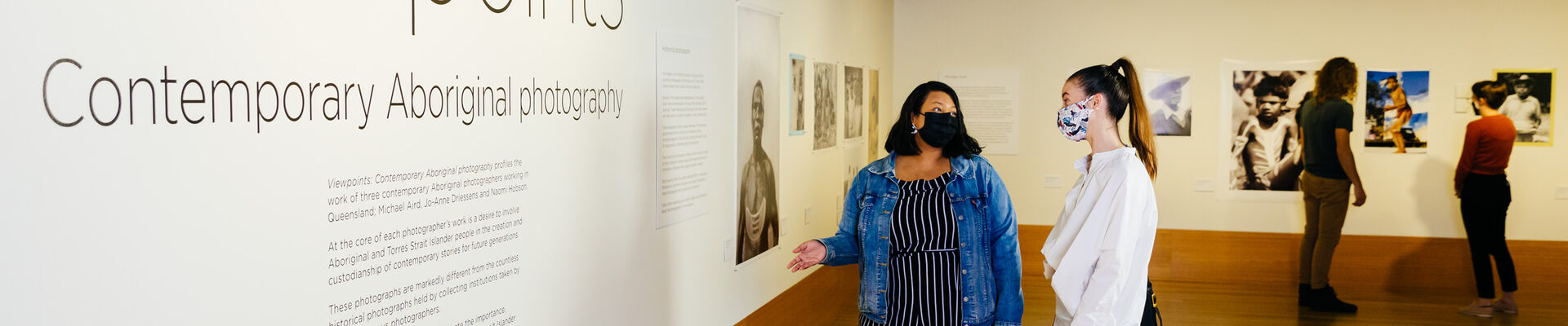 Two women look at the introduction text within the Viewpoints exhibition