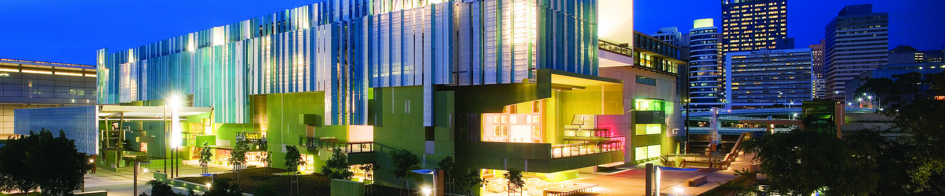 State Library of Queensland building lit up at night