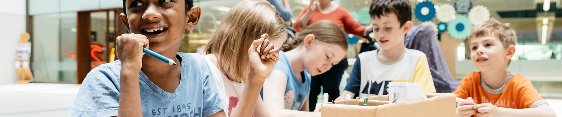 Kids working around a table at the Summer Festival State Library Queensland