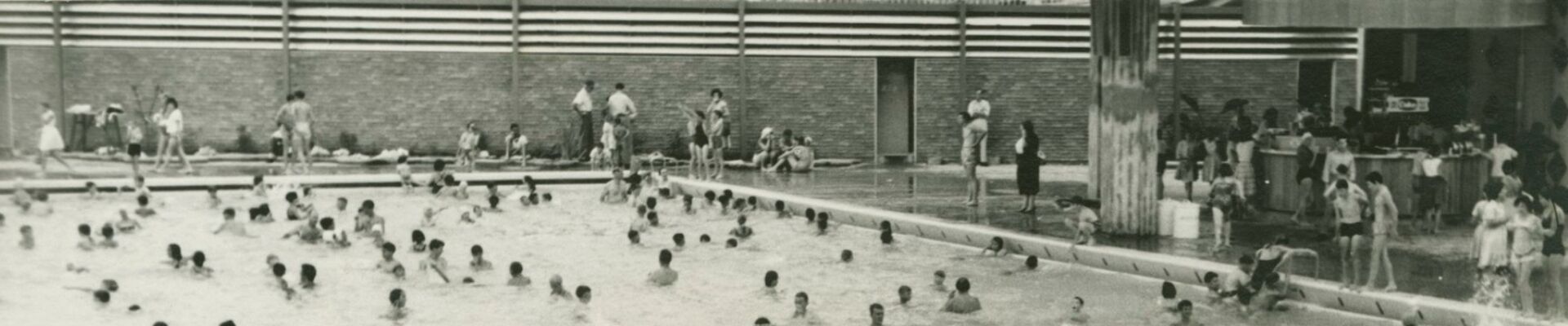 Young man diving into the busy pool