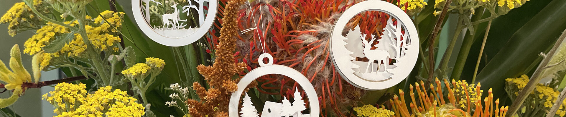 Laser cut xmas decorations hanging on tree
