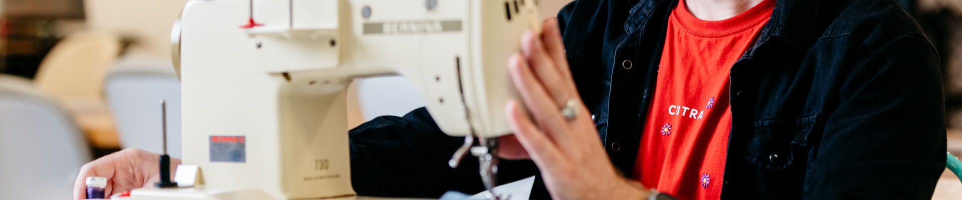 Teenager using a sewing machine