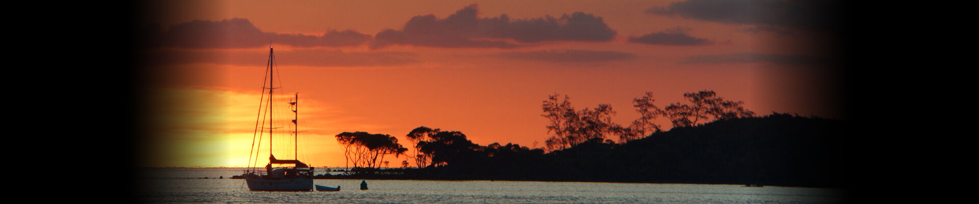 Sunset over water with boat