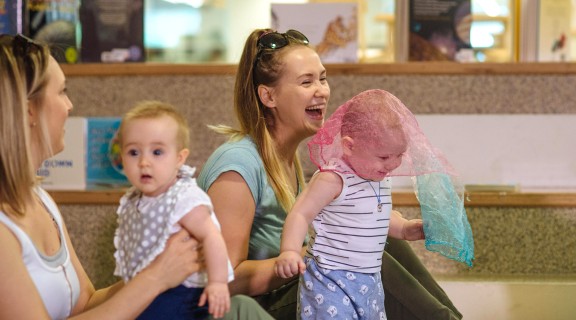 Two mothers singing to kids