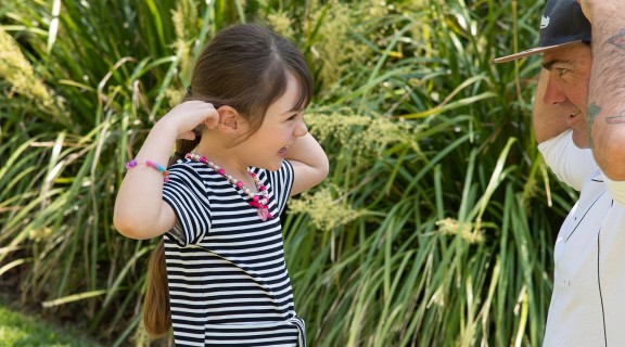 Child and man touching their own ears
