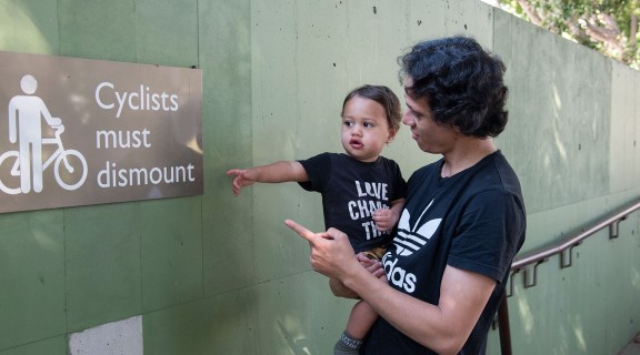 Woman and child pointing at a sign