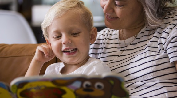 Mother and son reading his favourite book again