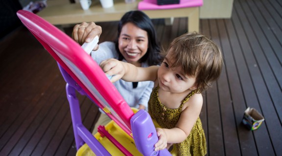 Mother and toddler drawing with chalk