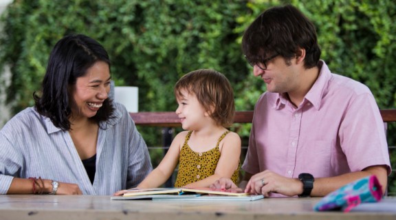 Mother and father reading with child