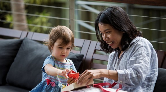 Mother and daughter looking at square tile