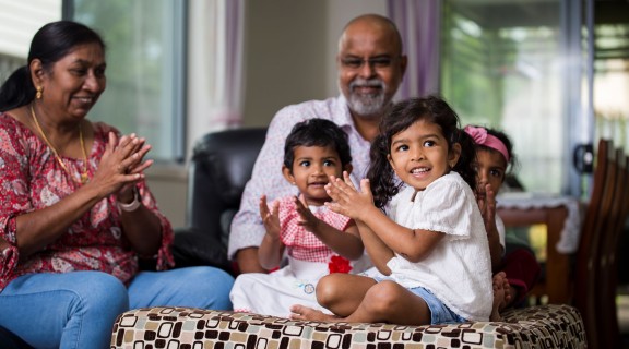 Grandparents and grandchildren singing and clapping together