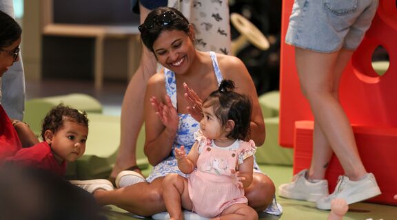Mother and child sing and clap together