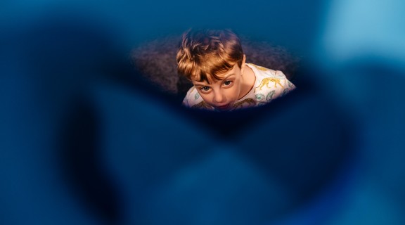 Child looking through a gap