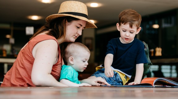 Mother reading with two young children