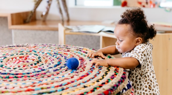 Little girl playing with textured surface