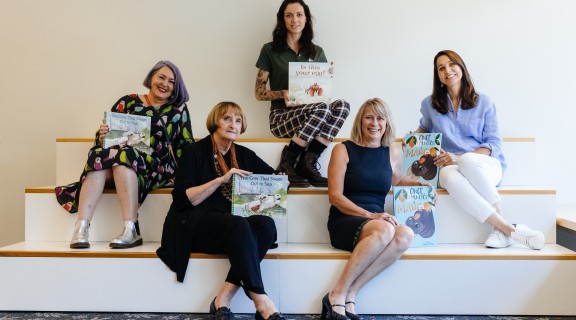 Authors and illustrators holding books they have worked on