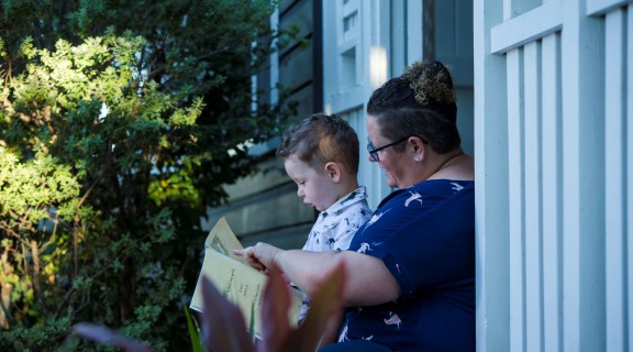 Mother and child reading outside