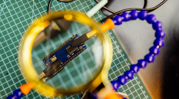 A photo of an arduino electronics board under a magnify glass