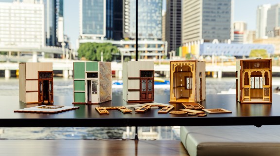 A row of queensland in miniature book nooks.