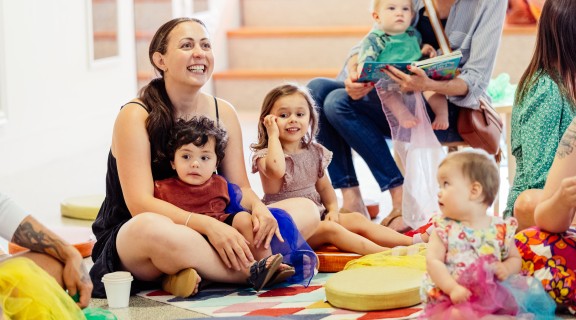 Families during Story Time in The Corner during Holiday Fun