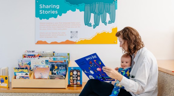 Mum and baby reading in library