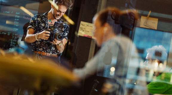A photo of people through a glass window