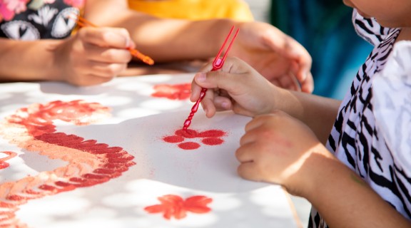 Child doing sand art