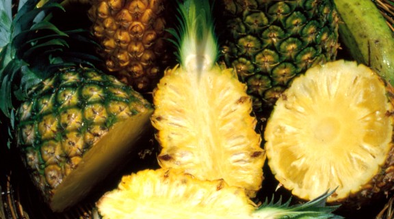 Array of juicy pineapples in a woven basket in Townsville, 1986