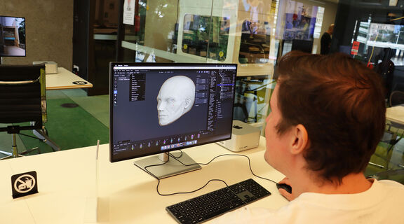 Person modeling a head in Blender