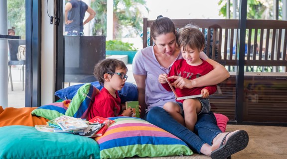 Mum with sons reading