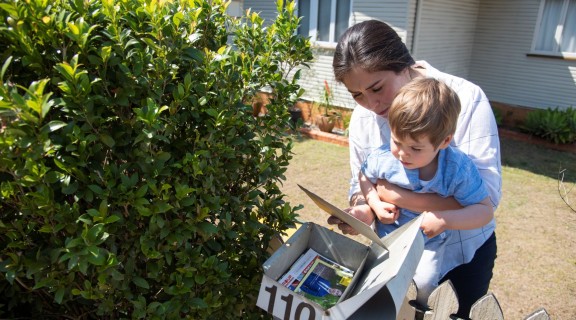 Mother and preschooler checking the mail outside