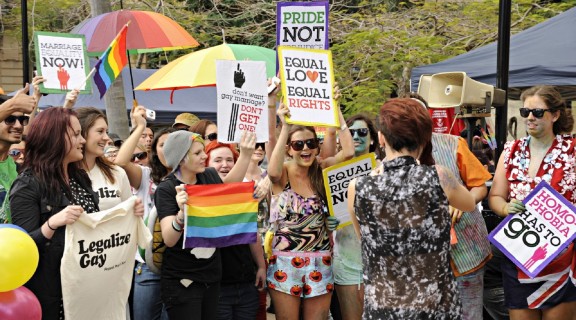 Group of supporters waving placards and banners at the rally