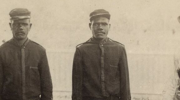 Frederic Charles Urquhart standing with three unidentified members of the Native Police Force, ca. 1885.