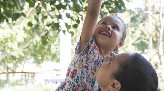 Mother and daughter exploring in their backyard