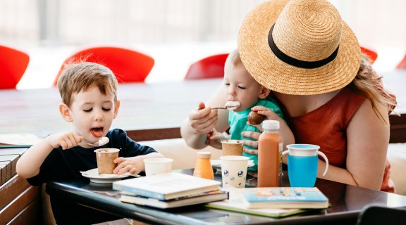 Woman with two young children with hot chocolates at the Library Cafe.