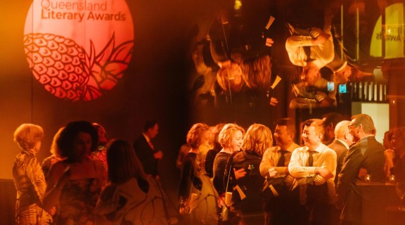 An unfocused image of people enjoying the Queensland Literary Awards after party.