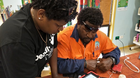 Indigenous Knowledge Centre Coordinator showing a community member who to use an iPad
