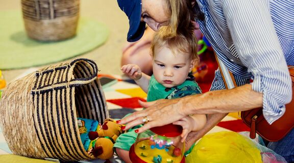 Adult and baby playing