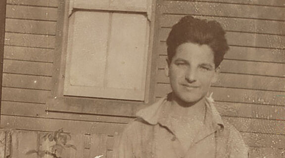 Informal portrait of Yvon Calmus, a young French war refugee 'souvenired' by members of the 2nd Field Artillery Brigade (2nd FAB) and brought back to Australia to live.
