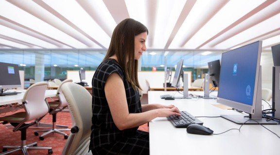 Woman logging into a State Library computer in the Infozone.