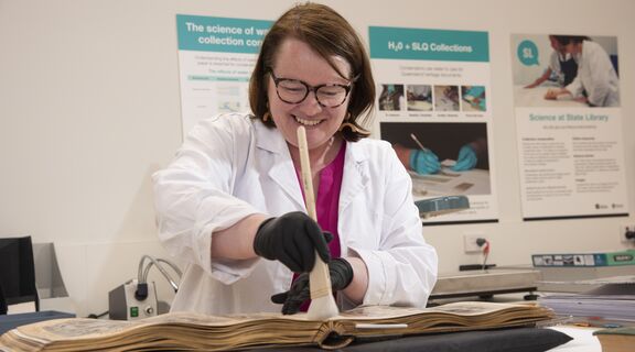 Specialist Conservator Melanie Sorenson working on a book.