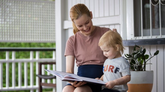Mother and child enjoy reading and singing rhymes